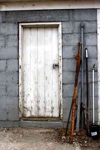 old-shed-door-with-metal-stakes